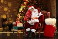 Santa Claus and little boy near Christmas tree Royalty Free Stock Photo