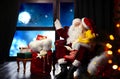 Santa Claus with little girl in armchair. Christmas time Royalty Free Stock Photo