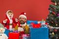 Santa Claus and little santa or elf with gift boxes Royalty Free Stock Photo
