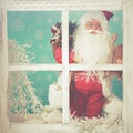 Santa Claus looking through a frozen window Royalty Free Stock Photo