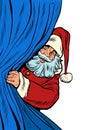 Santa Claus looks out from behind the curtain. Christmas background