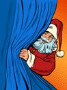 Santa Claus looks out from behind the curtain. Christmas background