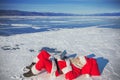 Santa Claus lying on the snow, looking at laptop news Royalty Free Stock Photo