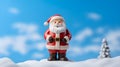 Santa Claus made by clay on blue sky with snowflake blur background for Christmas wallpaper background with text space.