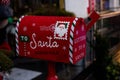 Santa Claus mailbox and gift with bow and ribbons.