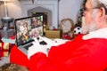 Santa claus making laptop christmas video call with four happy diverse families