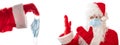 Santa Claus with a medical mask on pointing with both hands at a medical mask given to him by another Santa. Isolated, white Royalty Free Stock Photo