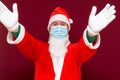 Santa Claus medical mask says there is no gift empty with his hands on red background