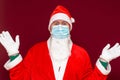 Santa Claus medical mask says there is no gift empty with his hands on red background