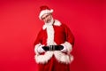 Santa claus with nasty smile posing  over red background Royalty Free Stock Photo