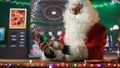 Santa Claus navigates web on his smartphone and checking gift lists Royalty Free Stock Photo