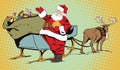 Santa Claus near magical sleigh.