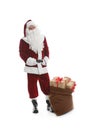 Santa Claus near sack of gifts on white background Royalty Free Stock Photo