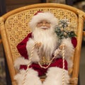 Santa Claus in New Year holds reins of sled, toy.