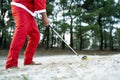 Santa Claus playing golf in the leisure time during daytime