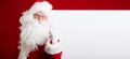 Santa Claus pointing in blank advertisement banner isolated on r