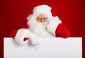 Santa Claus pointing in blank advertisement banner isolated on r Royalty Free Stock Photo