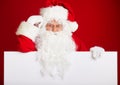 Santa Claus pointing in blank advertisement banner isolated on r Royalty Free Stock Photo