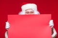 Santa Claus pointing in blank advertisement banner isolated on red background with copy space red leaf Royalty Free Stock Photo