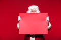 Santa Claus pointing in blank advertisement banner isolated on red background with copy space red leaf Royalty Free Stock Photo