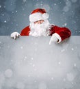 Santa Claus pointing on blank advertisement banner Royalty Free Stock Photo