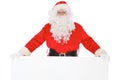 Santa Claus pointing on blank white wall, advertisement banner with copy space. Isolated on white background Royalty Free Stock Photo