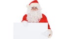 Santa Claus pointing on blank white wall, advertisement banner with copy space. Isolated on white background Royalty Free Stock Photo