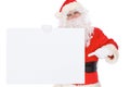 Santa Claus pointing on blank white wall, advertisement banner with copy space. Isolated on white background Royalty Free Stock Photo