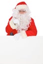 Santa Claus pointing on blank white wall, advertisement banner with copy space. Isolated on white background Royalty Free Stock Photo