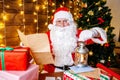 Santa Claus is preparing for Christmas, reading children`s letters. Mail of Santa Claus. Christmas decoration.