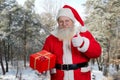 Santa Claus with present box outdoors. Royalty Free Stock Photo