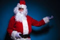 Santa Claus presenting on blue backgrorund Royalty Free Stock Photo