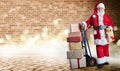 Santa Claus with presents on a delivery trolley in a postal theme with festive lighting and an industrial background