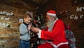 Santa Claus presents gift to happy boyr Royalty Free Stock Photo