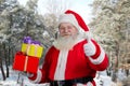 Santa Claus with presents outdoors. Royalty Free Stock Photo