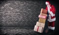 Santa Claus with presents stacked on a delivery trolley with a plain background and copy space