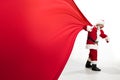 Santa Claus pulling huge bag full of christmas presents isolated on white background Royalty Free Stock Photo