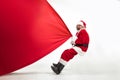 Santa Claus pulling huge bag full of christmas presents isolated on white background Royalty Free Stock Photo