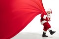 Santa Claus pulling huge bag full of christmas presents isolated on white background Royalty Free Stock Photo