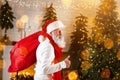 Santa Claus put presents box under the Christmas tree Royalty Free Stock Photo