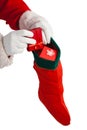 Santa claus putting presents in christmas stockings Royalty Free Stock Photo