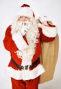 Santa claus, quiet and secret for present in studio for Christmas giving, festive season joy or fun. Male person Royalty Free Stock Photo