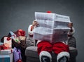 Santa Claus reading business news Royalty Free Stock Photo