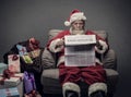 Santa Claus reading business news Royalty Free Stock Photo