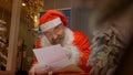 Santa Claus reading christmas letter from child Royalty Free Stock Photo