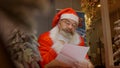 Santa Claus reading christmas letter from child Royalty Free Stock Photo