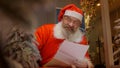 Santa Claus reading christmas letter from child Royalty Free Stock Photo