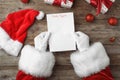 Santa Claus reading letter from child at table Royalty Free Stock Photo