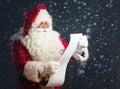 Santa Claus reading from a long list Royalty Free Stock Photo