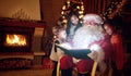 Santa Claus reading magic book with children